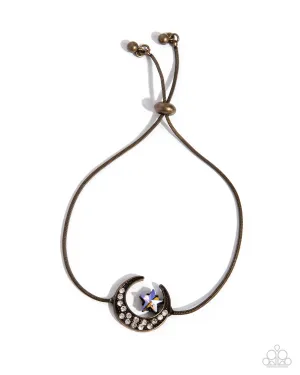 Abstract Atmosphere - Brass - White Rhinestone Crescent Moon Paparazzi Lariat Bracelet